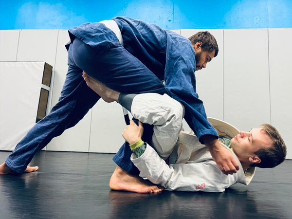 Two of our adult members training in class. The athlete on the bottom is working to establish what is called a De La Riva Guard.